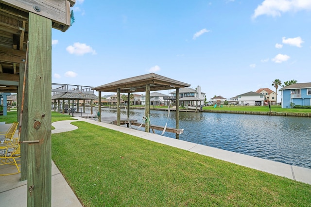 dock area featuring a lawn and a water view