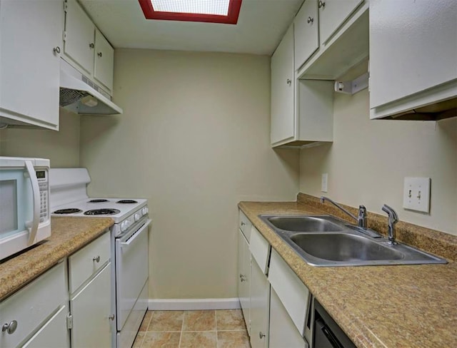 kitchen featuring white appliances, white cabinetry, sink, and a skylight