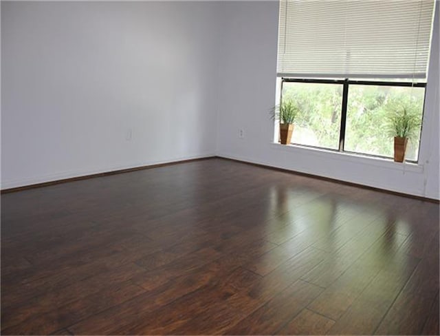 spare room with dark hardwood / wood-style flooring