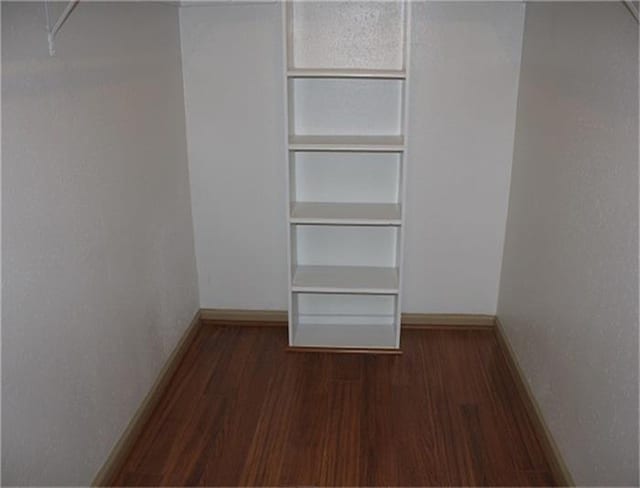 walk in closet featuring dark wood-type flooring