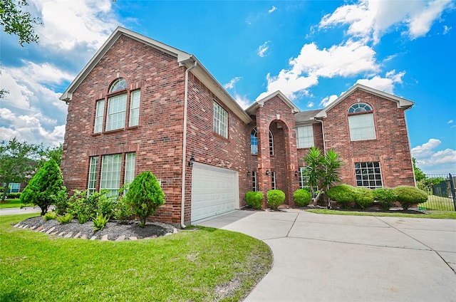 front of property featuring a front lawn and a garage