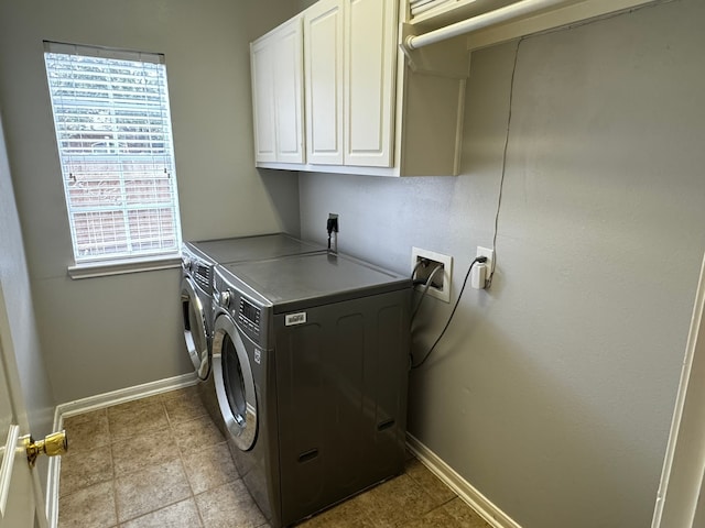 washroom featuring cabinets and washing machine and dryer