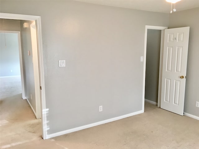 unfurnished room with light carpet