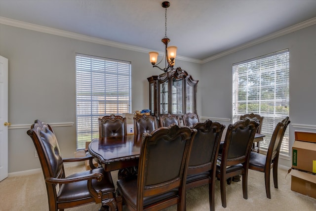 dining room with a chandelier, crown molding, and plenty of natural light