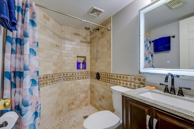 bathroom with tile walls, vanity, a shower with curtain, and toilet