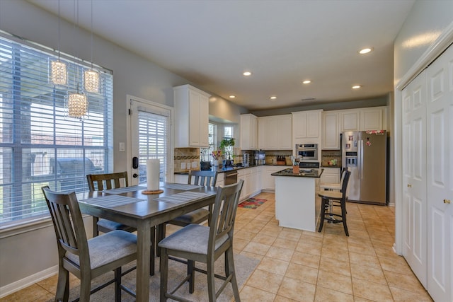 dining area featuring light tile patterned flooring