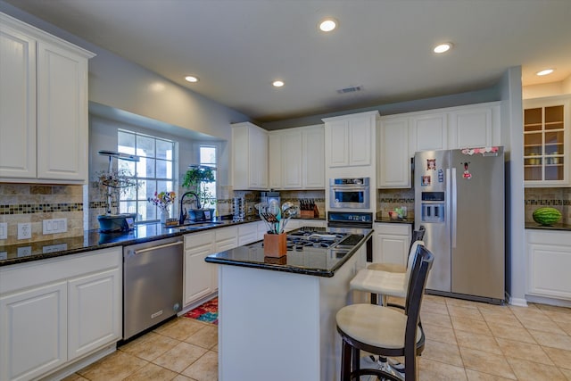 kitchen with appliances with stainless steel finishes, white cabinetry, and sink