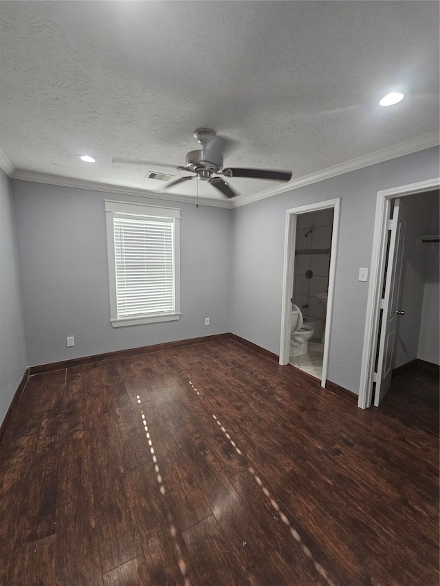 unfurnished bedroom with ornamental molding, connected bathroom, ceiling fan, and dark wood-type flooring