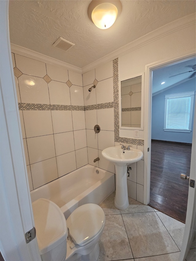 bathroom with a textured ceiling, crown molding, toilet, and hardwood / wood-style flooring