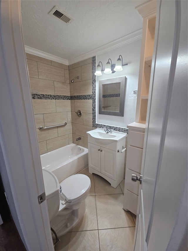 full bathroom with tiled shower / bath combo, vanity, crown molding, and toilet