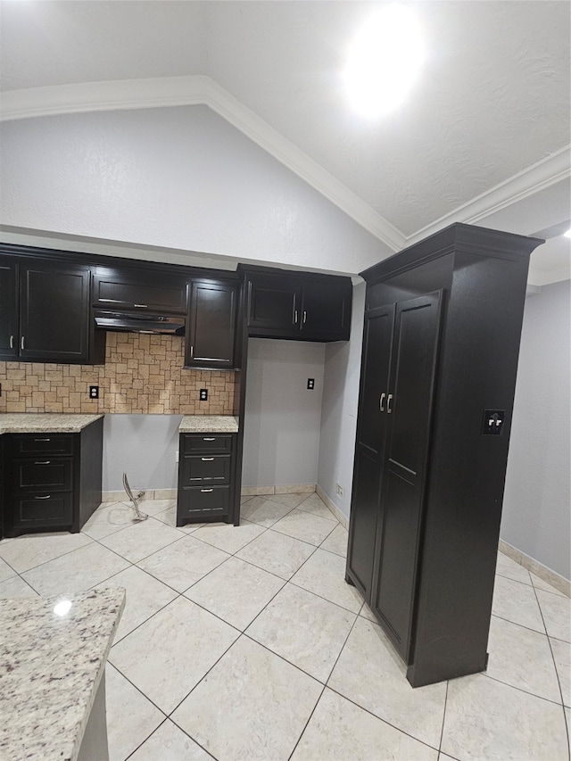 kitchen featuring range hood, vaulted ceiling, decorative backsplash, light tile patterned floors, and crown molding