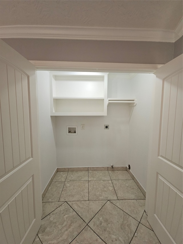 laundry area featuring light tile patterned flooring, washer hookup, hookup for an electric dryer, crown molding, and hookup for a gas dryer