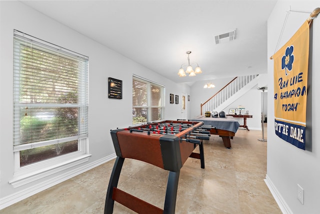 recreation room featuring a chandelier