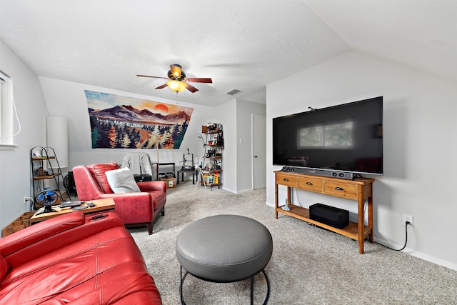 living room with a textured ceiling, carpet, lofted ceiling, and ceiling fan