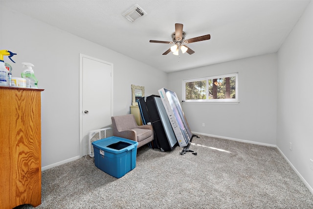 miscellaneous room with dark carpet and ceiling fan