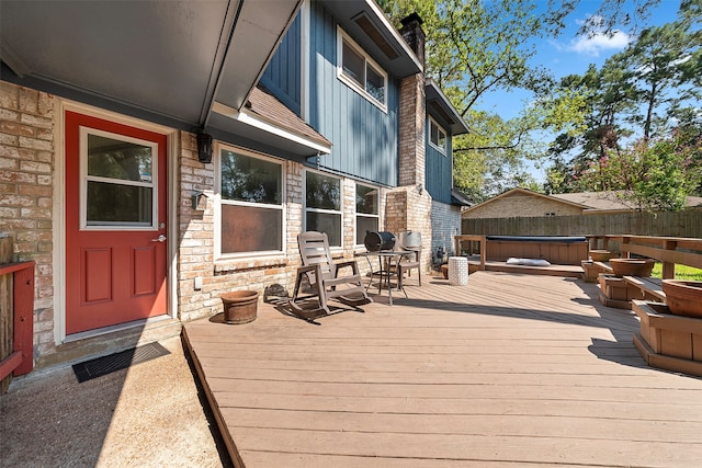 wooden deck with a hot tub