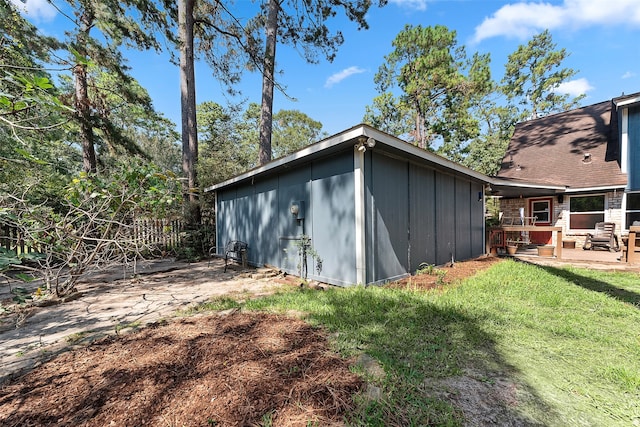 view of outbuilding featuring a lawn