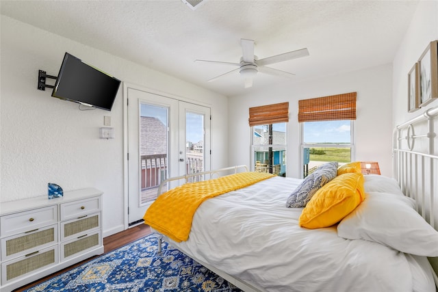 bedroom with wood-type flooring, a textured ceiling, access to exterior, ceiling fan, and french doors