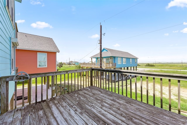 wooden terrace featuring a yard