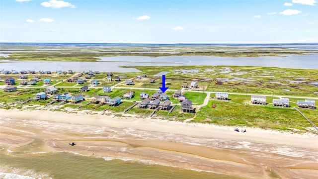 birds eye view of property featuring a water view and a view of the beach