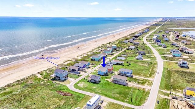 birds eye view of property with a view of the beach and a water view