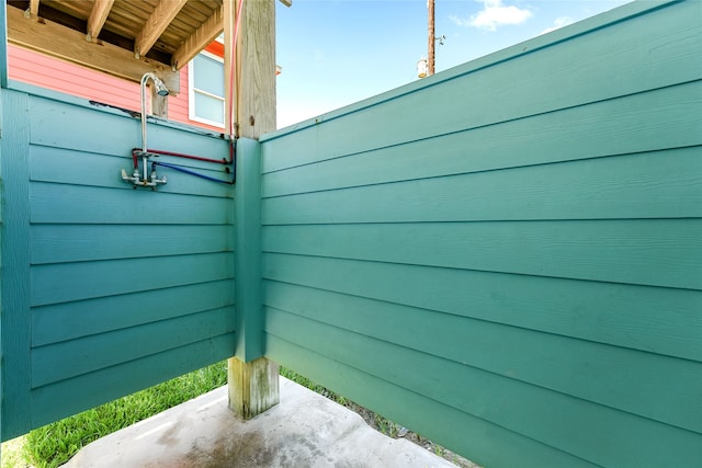 exterior space with wood walls and concrete flooring