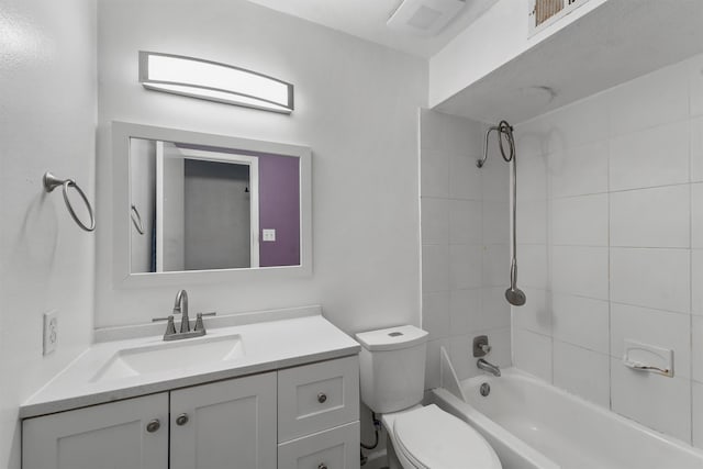 full bathroom with vanity, toilet, and tiled shower / bath