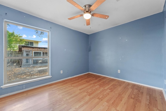 empty room featuring wood-type flooring and ceiling fan