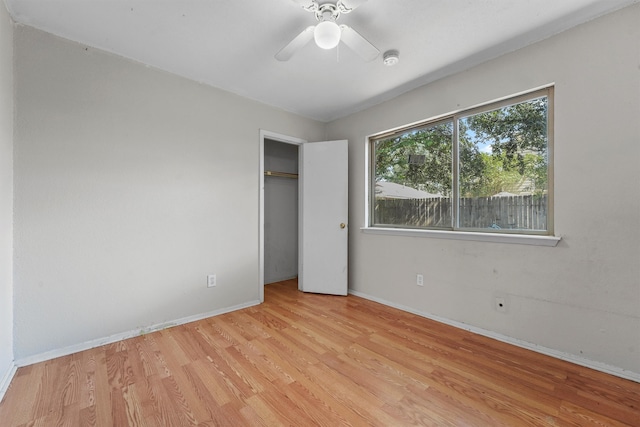 unfurnished bedroom with ceiling fan, a closet, and light hardwood / wood-style floors