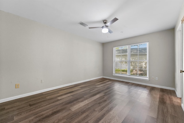 empty room with ceiling fan and dark hardwood / wood-style floors