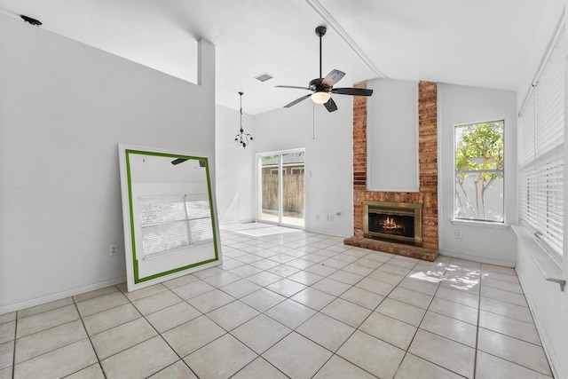 unfurnished living room featuring high vaulted ceiling, a brick fireplace, ceiling fan, and light tile patterned floors