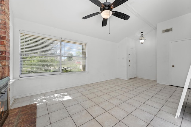 tiled empty room with ceiling fan and lofted ceiling