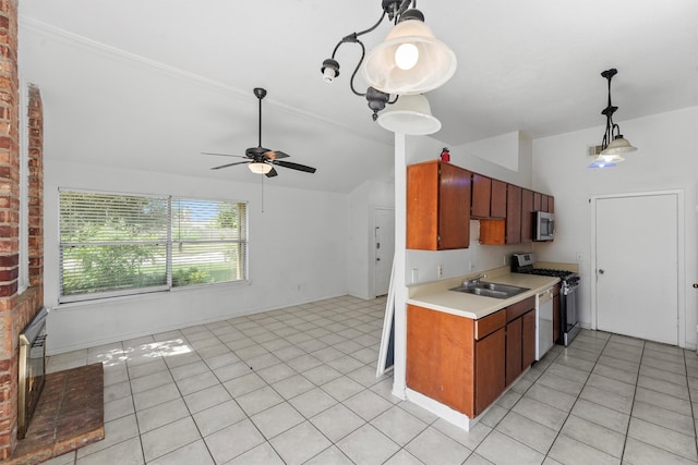 kitchen with light tile patterned flooring, sink, a fireplace, appliances with stainless steel finishes, and ceiling fan