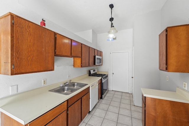 kitchen with pendant lighting, stainless steel appliances, light tile patterned floors, and sink