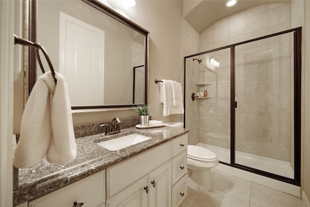 bathroom featuring walk in shower, vanity, tile patterned flooring, and toilet