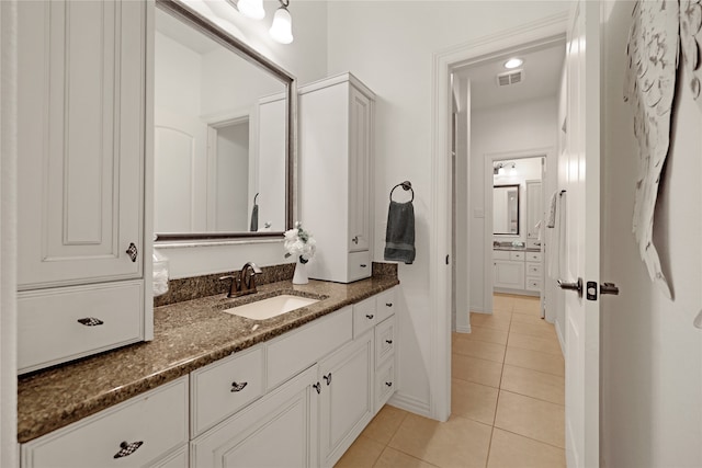 bathroom with tile patterned floors and vanity