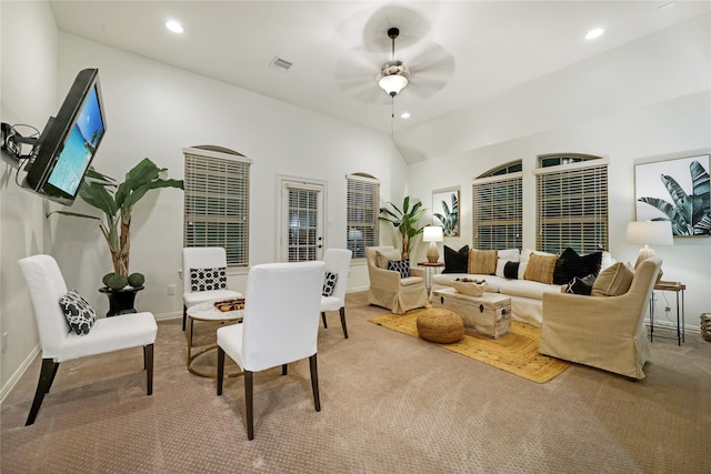 carpeted living room with ceiling fan