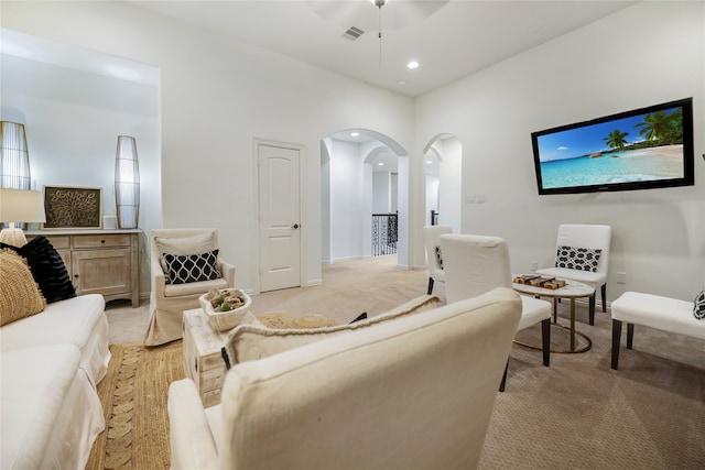 carpeted living room featuring ceiling fan