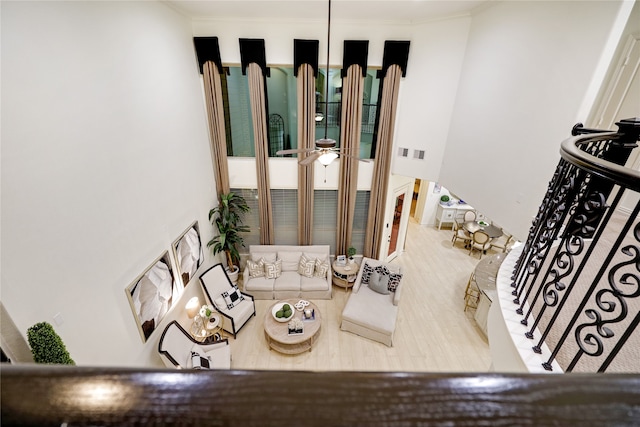 living room featuring wood-type flooring and ornamental molding