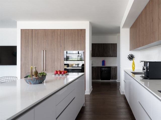 kitchen featuring appliances with stainless steel finishes, dark hardwood / wood-style floors, sink, and white cabinets