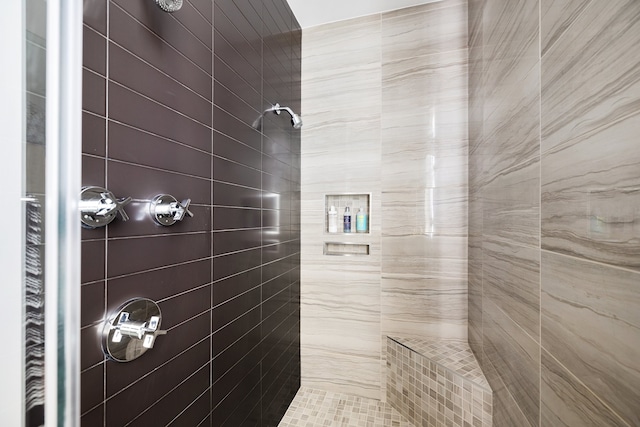 bathroom with tiled shower