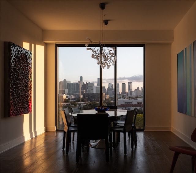 dining space featuring a notable chandelier and dark hardwood / wood-style flooring