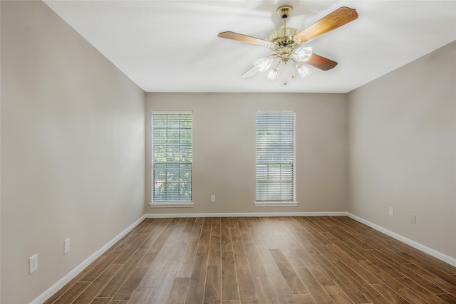 spare room featuring ceiling fan and dark hardwood / wood-style flooring