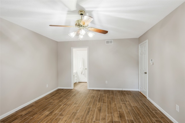 empty room featuring dark hardwood / wood-style floors and ceiling fan