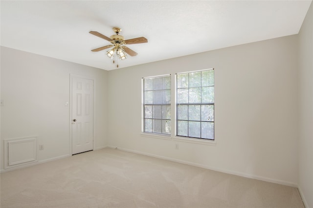 carpeted empty room featuring ceiling fan