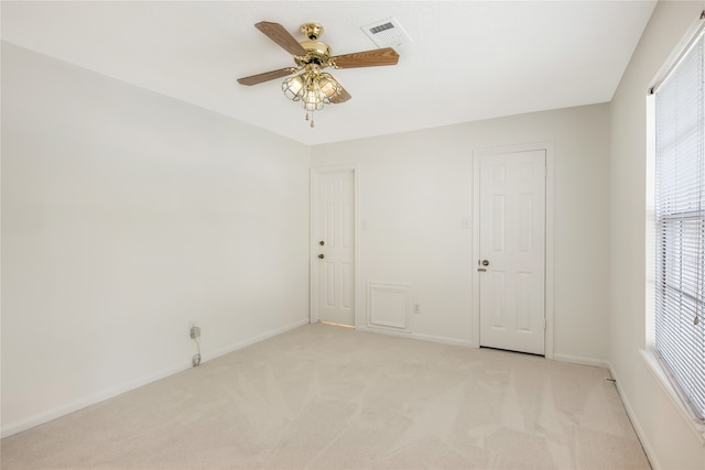 unfurnished room featuring ceiling fan and light carpet