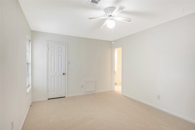 carpeted spare room with ceiling fan