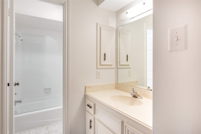 bathroom featuring tile patterned floors, vanity, and tiled shower / bath