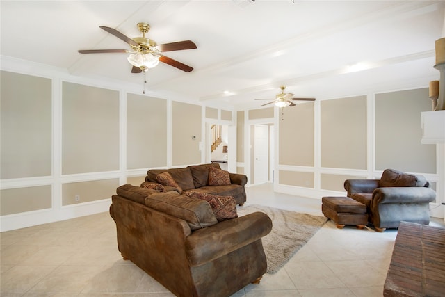 living room featuring ceiling fan, light tile patterned floors, and crown molding