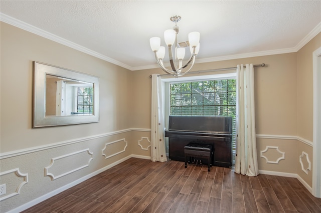 interior space featuring a chandelier, a textured ceiling, crown molding, and dark wood-type flooring